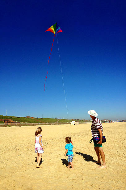 istock Family Flying Kite on Beach 174932189