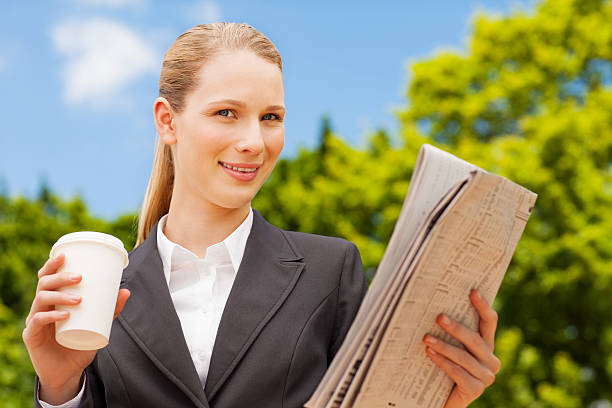 istock Female Executive Holding Newspaper And Disposable Cup 174932282