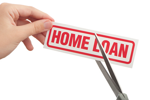 Cutting home loan on white background