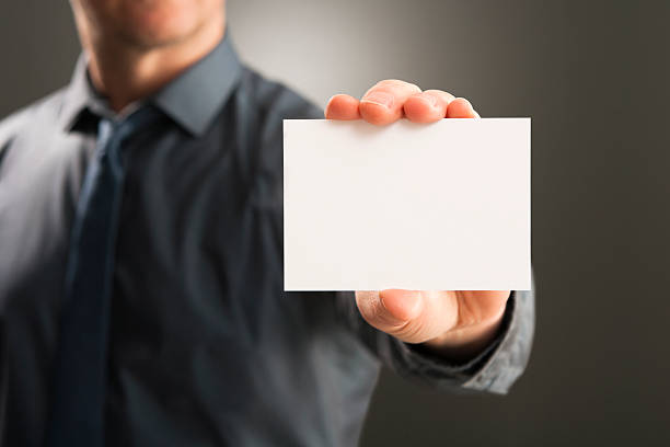 istock Businessman holding up blank white card 174932877
