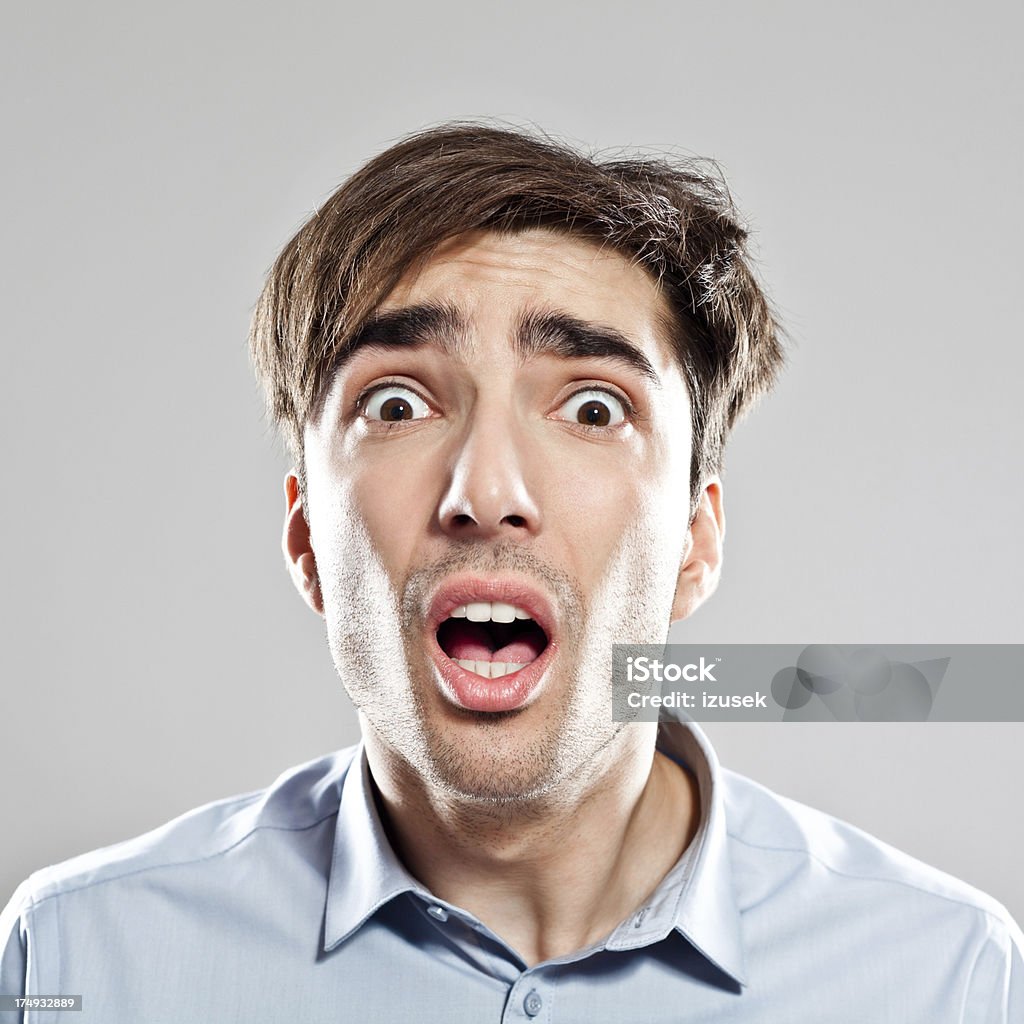 Scared Businessman Portrait of young scared businessman staring at the camera. 25-29 Years Stock Photo
