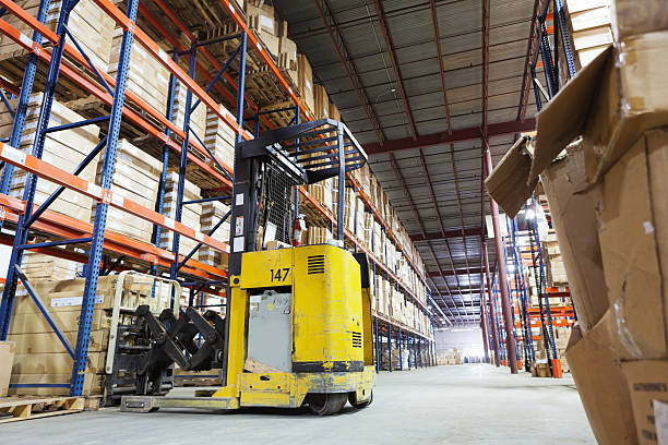 istock Forklift truck in shipping distribution warehouse lined with boxes 174932894