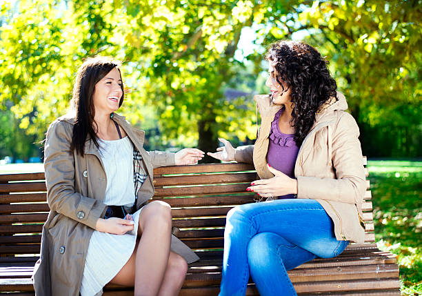 istock Two friends sitting on the bench in park. 174932965