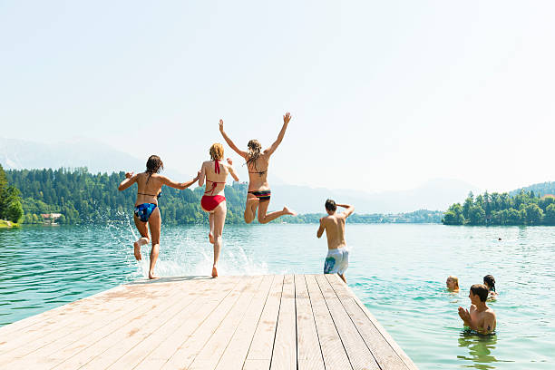istock People in bikini jumping in water 174933407