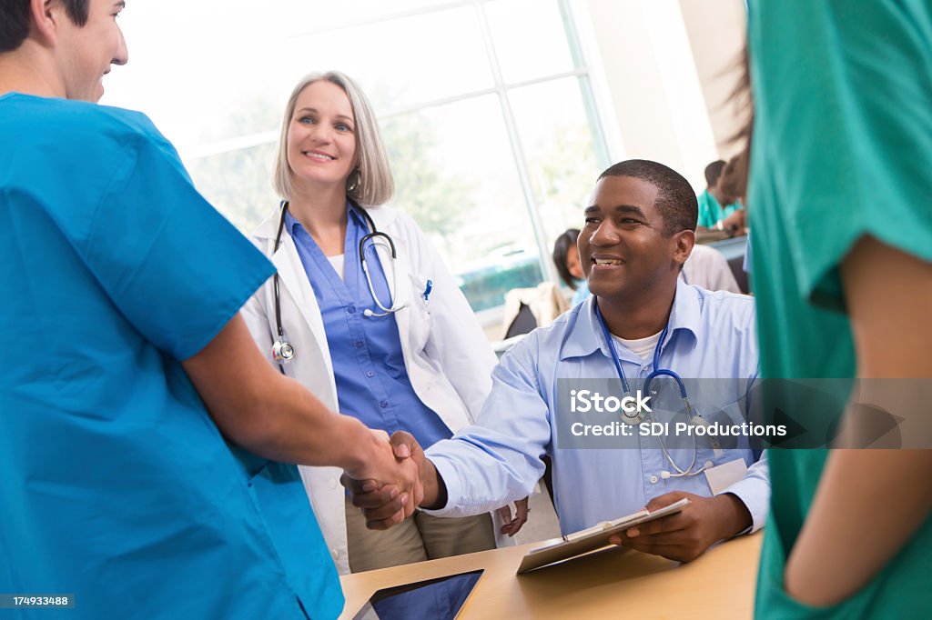 Medical school professor welcoming college student to lecture Education Registration Event Stock Photo