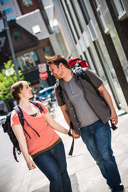 Young couple backpackers in city