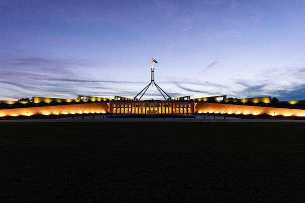 Australian Parliament House illuminated with dark blue sky