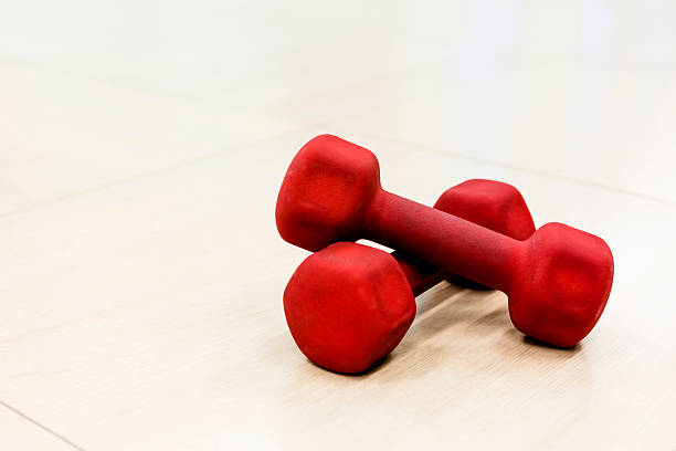 istock Red dumbbells on a wooden floor 174933914