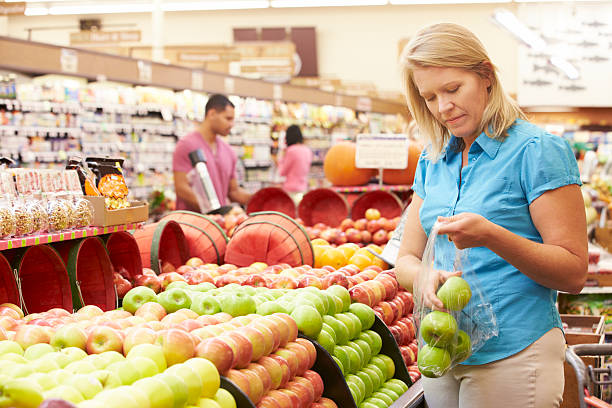 istock Woman At Fruit Counter In Supermarket 174934982