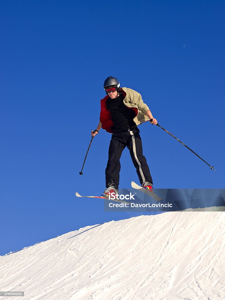 ski  jump "Young boy practising ski jumps on winter slope in Slovenia. Vivid colours, blue sky." Activity Stock Photo