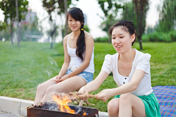 istock Young woman on vacation having barbecue 174935171