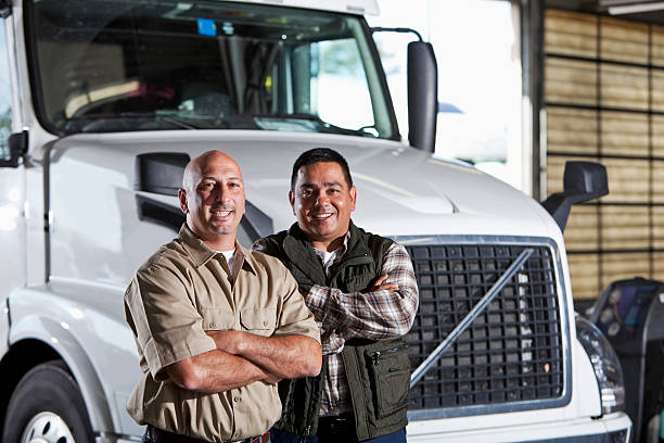 istock Multi-ethnic men standing next to semi-truck 174935625