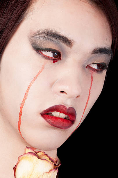 istock Closeup of crying vampire with dried rose 174935789