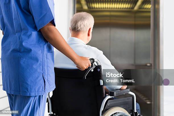 Senior Patient In Wheelchair Stock Photo - Download Image Now - Elevator, Hospital, In Front Of