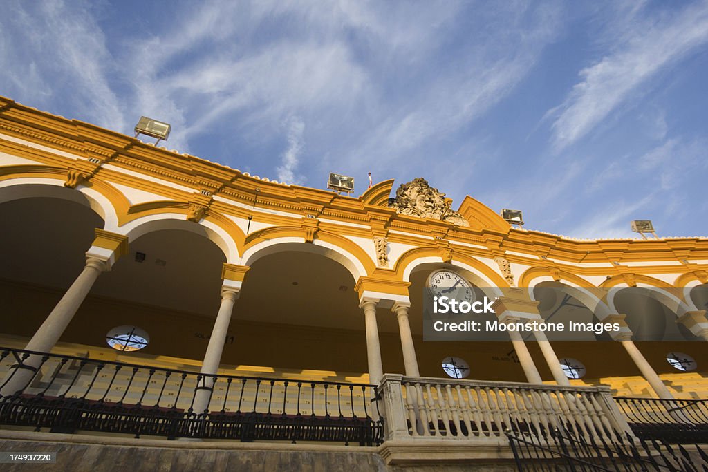 Bullring in Seville, Spain "The Plaza del Toros is Spain's oldest bullring. Located in the El Arenal district of Sevilla, it is easily recognisable owing to its white and ochre facade." Clock Stock Photo