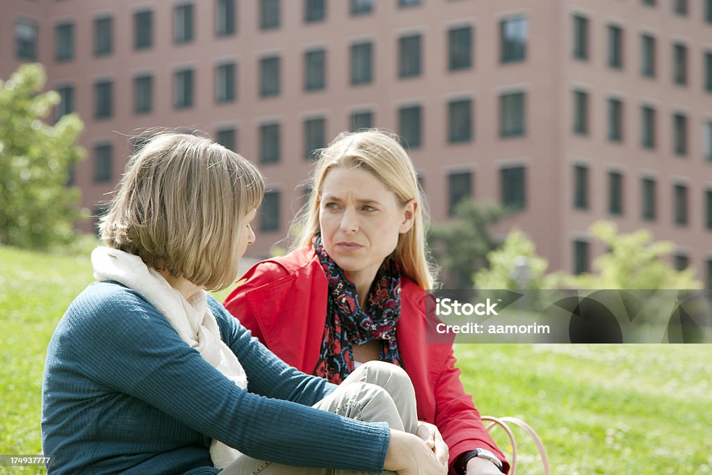 Mature woman with her mother Mature woman talking with her mother at the park. Daughter Stock Photo