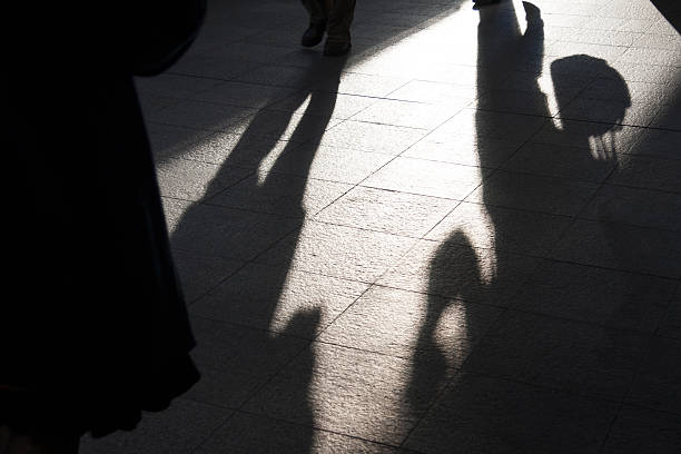 istock Morning sun casting Silhouette of people passing by. 174938517
