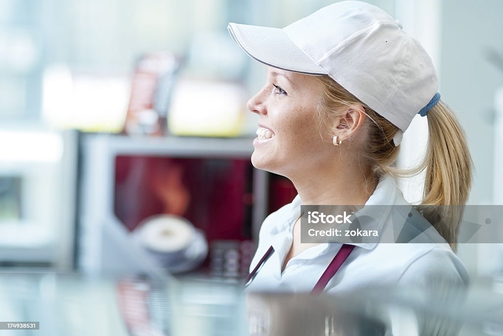 Waitress Waitress standing behind the counter. Fast Food Restaurant Stock Photo