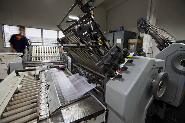 istock Paper signatures being folded at a printing factory. 174938792