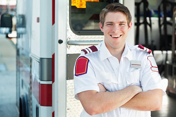 istock Confident Paramedic smiling in front of ambulance bus 174939144