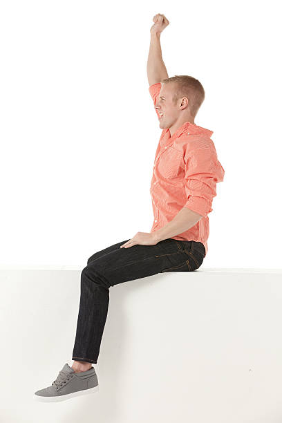 istock Man sitting on the ledge of a wall 174939341