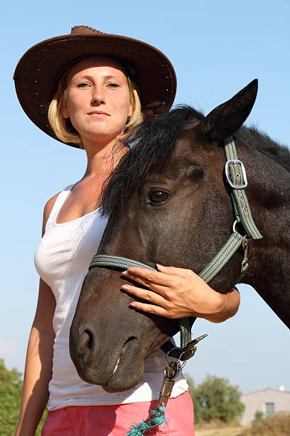 istock young woman with horse 174939698