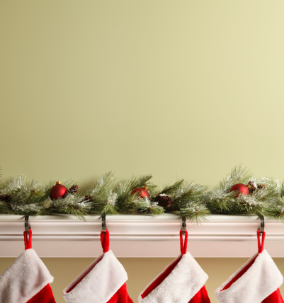 Christmas stockings hanging from a mantelpiece.To see more holiday images click on the link below: