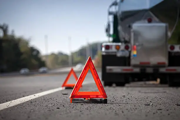 Photo of Warning Reflectors On Highway Indicating Disabled Truck