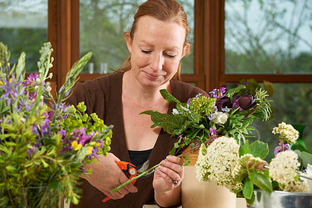 istock Florist Working On Arrangement In Flower Shop 174940842