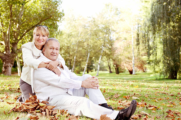 istock Mature couple relaxing in a park 174941348