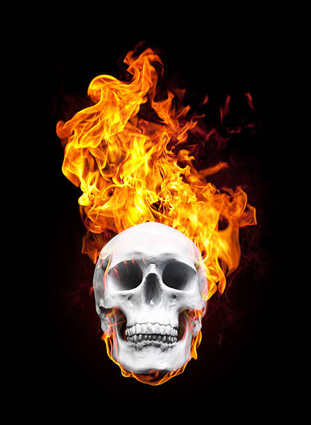 istock Human skull burning in flames isolated on black 174942137