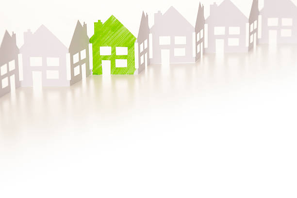 istock Paper chain houses one coloured green 174942138