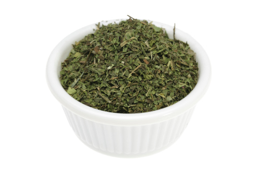 Dried mint in a small white bowl