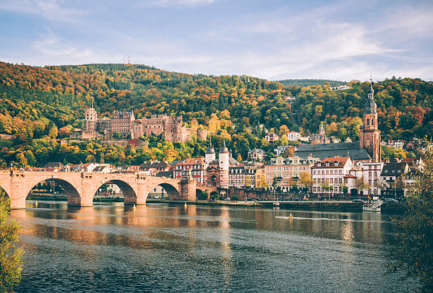 Heidelberg with the Alte Brucke in autumn Heidelberg with the Alte Brucke, Heidelberger Schloss and the Heiliggeistkirche heidelberg germany photos stock pictures, royalty-free photos & images