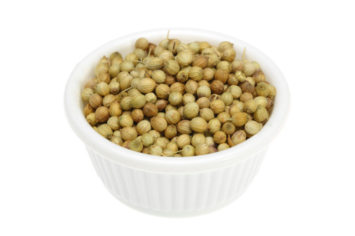 Coriander seeds in a small white bowl