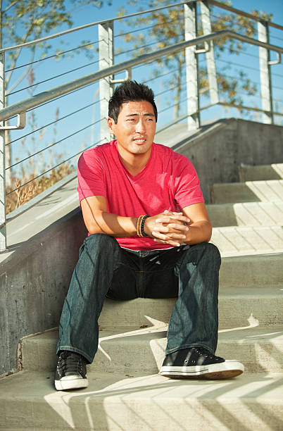 istock Korean Man Sitting on Concrete Stairs 174942555