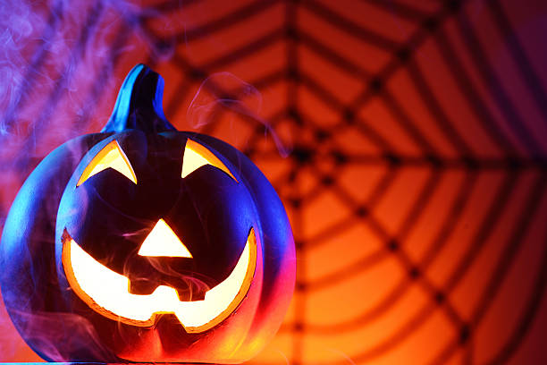 istock Halloween pumpkin in dark blue with spider web and smoke 174942713