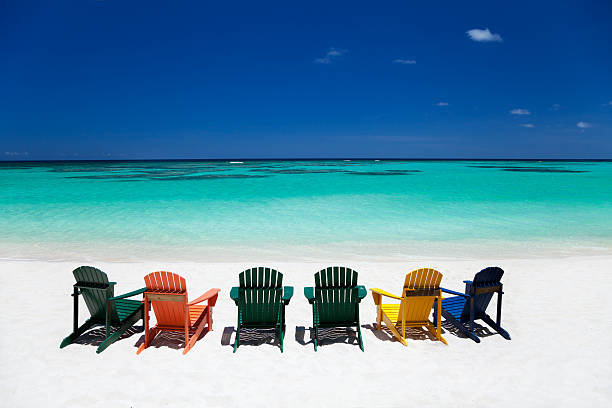 istock colorful empty adirondack chairs at a tropical Caribbean beach 174942885