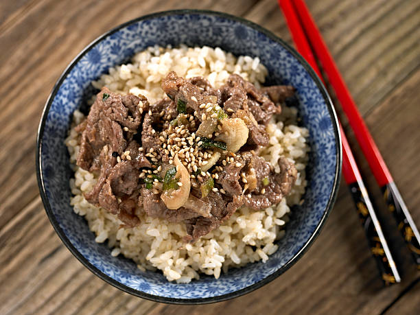 Bulgoki over Brown Rice Bulgoki over Cooked Brown Rice. bulgoki stock pictures, royalty-free photos & images