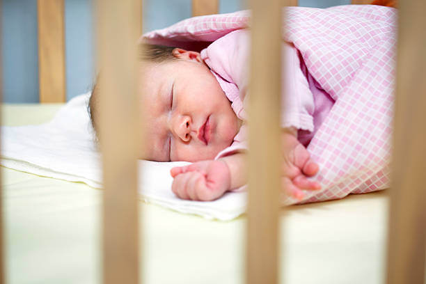 istock Newborn baby sleeping in crib 174944248