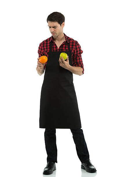 istock Man holding an orange and apple 174944283