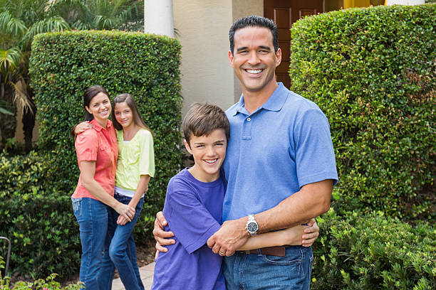 istock Happy Family Embracing In Lawn 174944408
