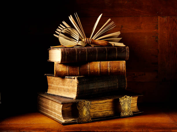 istock Magnifying Glass and a Stack of Antique Books 174944672