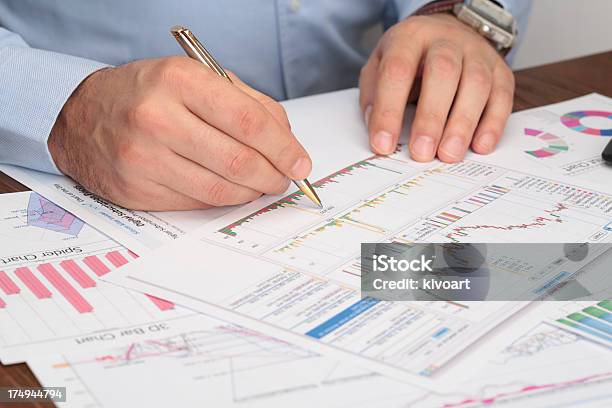 Business Meeting Mans Hands Pointing On Graphs Stock Photo - Download Image Now - Analyzing, Bank Account, Bank Statement