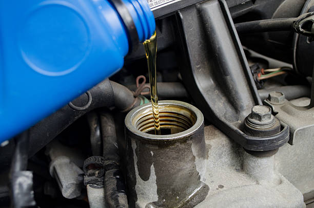 istock auto industry; engine oil poured by mechanic 174945016