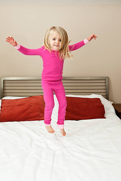 istock Girl Jumping on a Bed 174946114