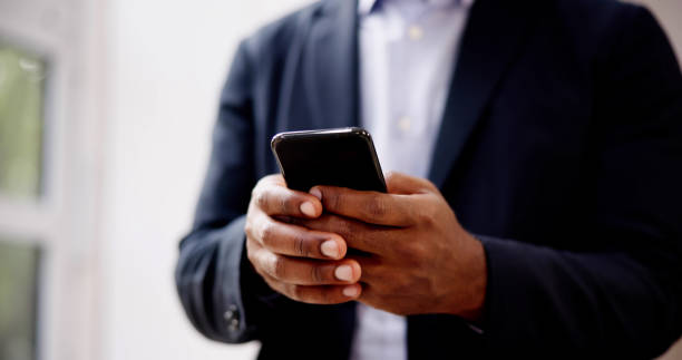 istock African Man Holding Smartphone 1749461344