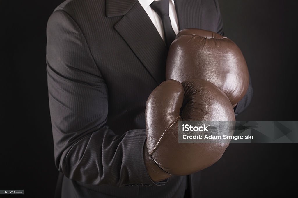 businessman with boxing gloves businessman in black suit with vintage boxing gloves; on black backgroundsee my Adult Stock Photo