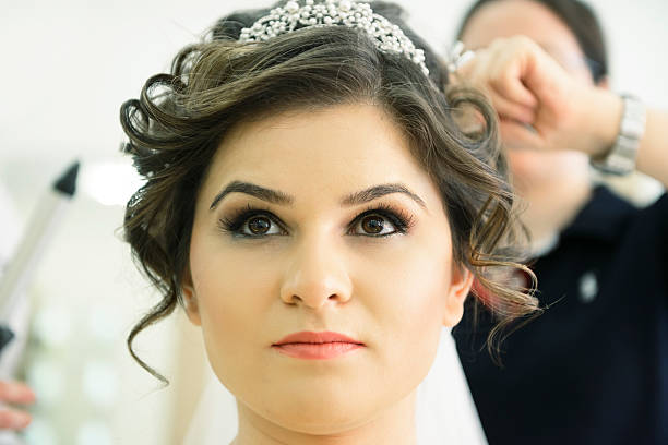 Portrait of beautiful brunette bride front of the wall.