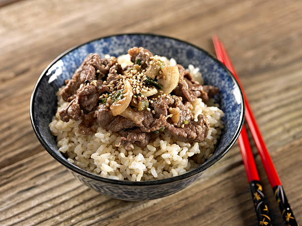 Bulgoki over Brown Rice Bulgoki over Cooked Brown Rice. bulgoki stock pictures, royalty-free photos & images